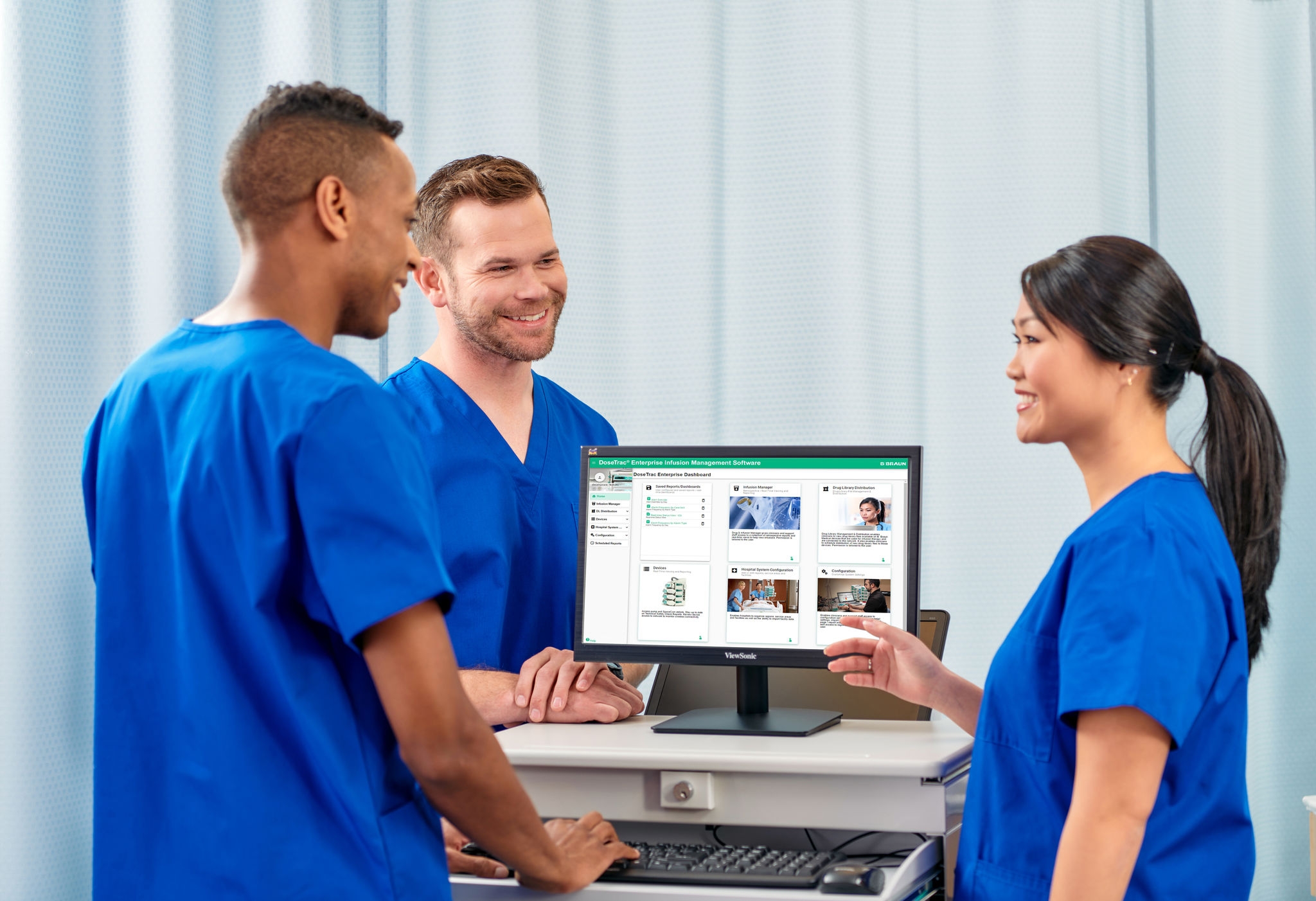 Nurses looking at a computer screen displaying DoseTrac Enterprise Infusion Management Software.