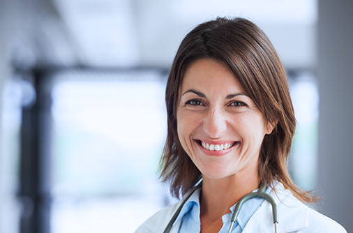 Close-up of a provider smiling with a stethoscope around their neck.