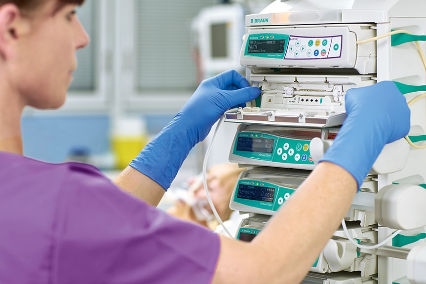 nurse places disposables in the infusomat space infusion pump